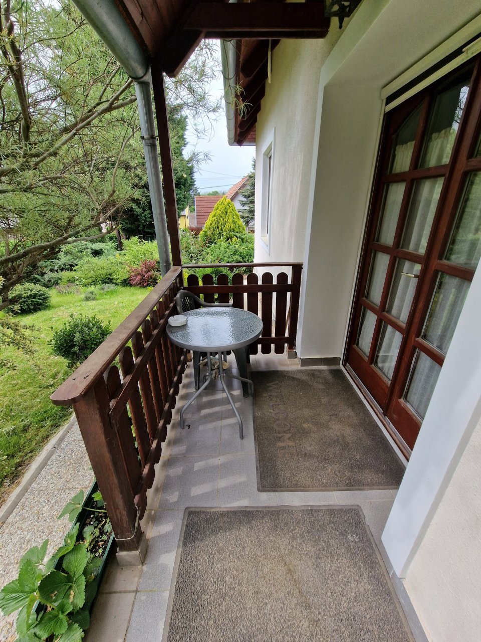 Idyllischer Südbalkon: Grüne Ausblicke und private Ruheoase mit charmantem Holzgeländer