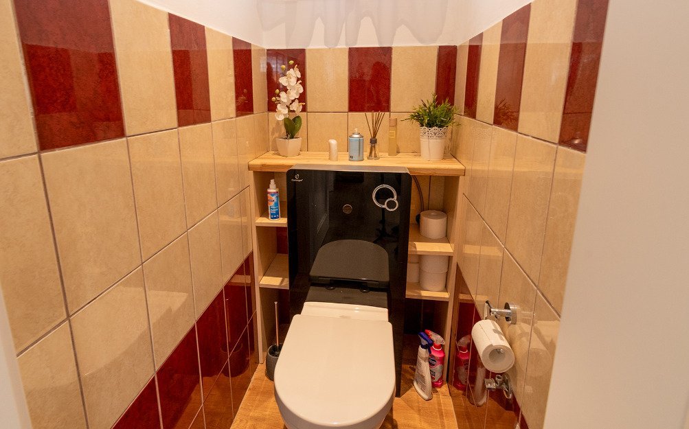 Modernes Gäste-WC mit praktischer Waschtischanlage und hochwertiger Keramikverkleidung Modernes Gäste-WC mit praktischer Waschtischanlage und hochwertiger Keramikverkleidung